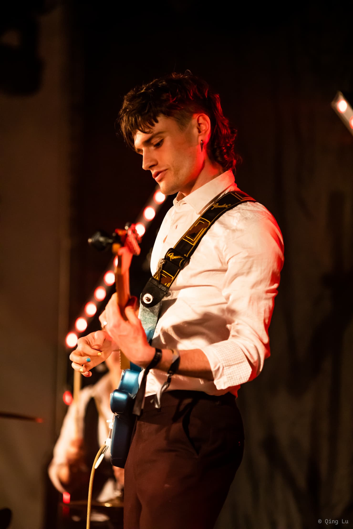 Noah playing guitar on stage