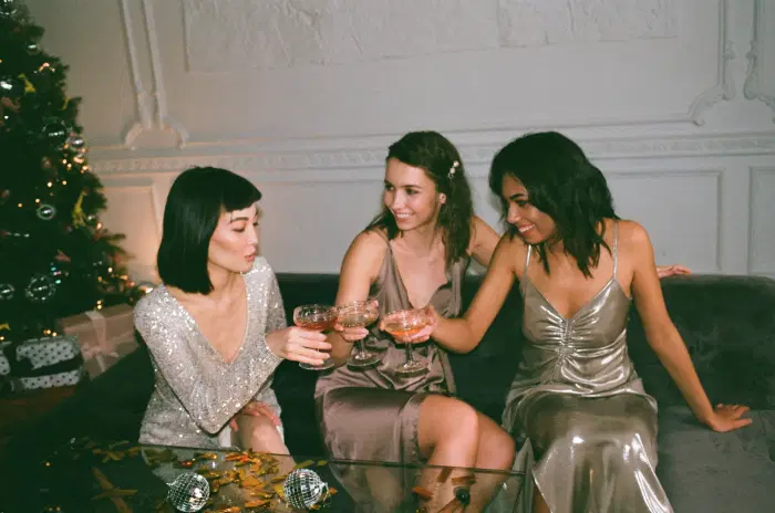 3 women clinking glasses at a Christmas party